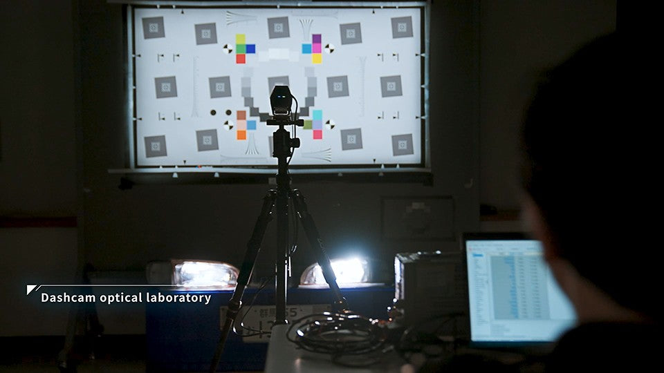 Camera under test against a resolution and colour chart in JET's dashcam optical laboratory