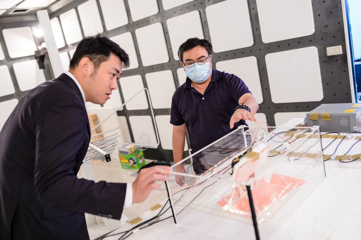 JET engineers preparing a test fixture inside the RF semi-anechoic chamber at the Taipei labs